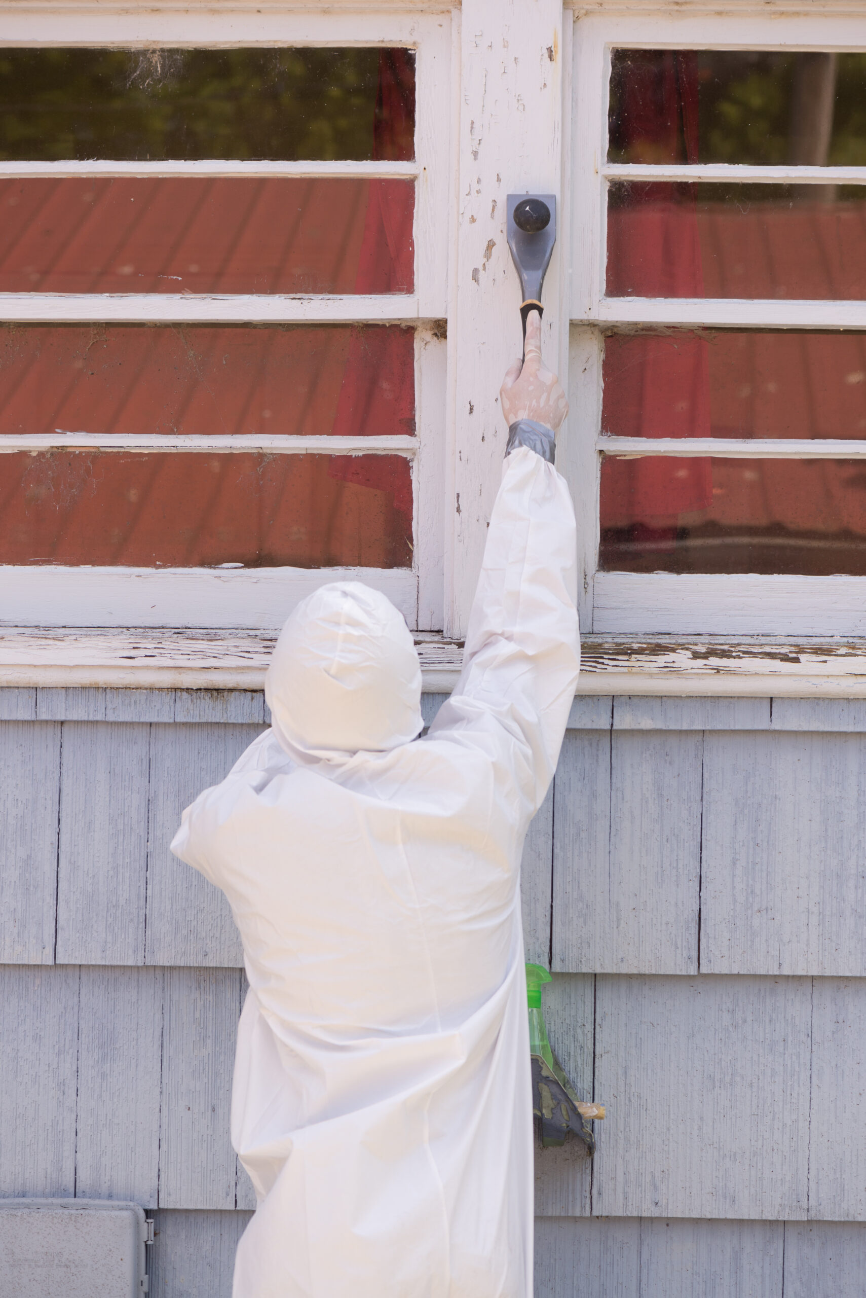 A,House,Painter,In,A,Hazmat,Suit,Scrapes,Off,Dangerous